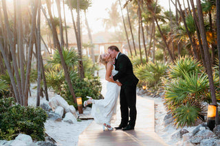 Photograph of bride and groom embracing at Valentin Imperial, Riviera Maya