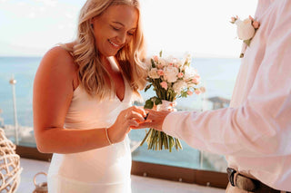 Photograph of a bride placing the ring on her soon-to-be husband's finger, captured by a DreamArt photographer
