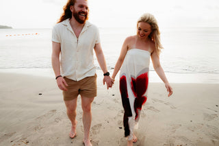 Photograph of a couple holding hands on the beach at their St. Lucia hotel