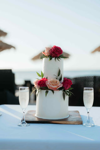 Photograph of a wedding cake at a beach wedding ceremony