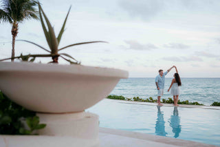 Photograph of couple dancing by their hotel pool, captured by a DreamArt photographer