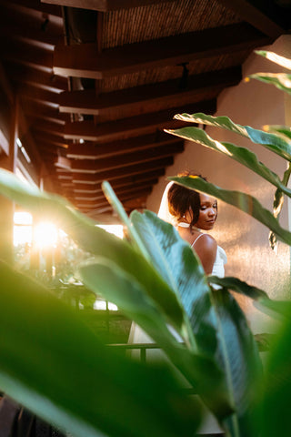 Photograph of a bride looking over her shoulder, captured by a DreamArt photographer