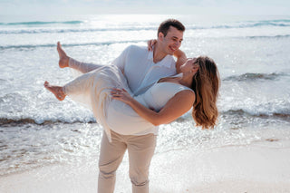 Photograph of an engaged couple on the beach taken by a DreamArt photographer