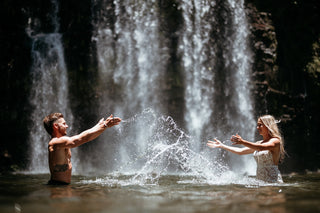 Photograph of a couple playing in a waterfall, taken by a DreamArt Photography photographer