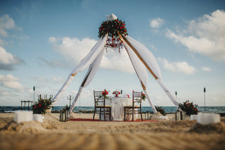 A romantic private dinner set-up on the beach at a luxury hotel in the riviera maya, photographed by a cancun engagement photographer