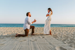 An engaged couple's reaction on the beach during golden hour shot by a Cancun engagement photographer