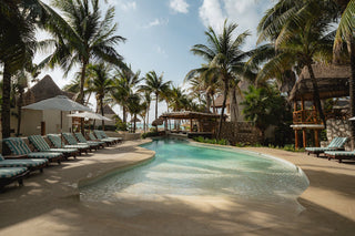 Pool photoshoot by photographer with loungers in tropical setting at Mahekal Beach Resort