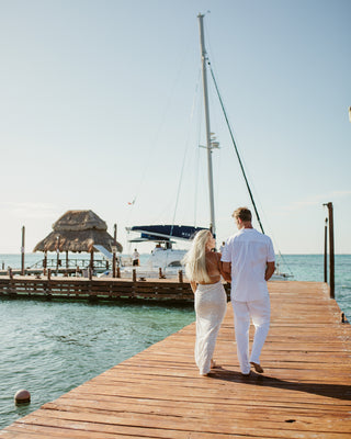 A couple walking on a pier during their Mia Reef Isla Mujeres Photoshoot