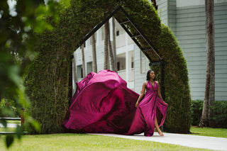 Flying dress photoshoot with photographer capturing model in magenta at Secrets Wild Orchid Montego Bay in Jamaica