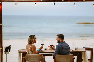 Photoshoot by photographer of romantic couple having dinner on the beach at Viceroy Riviera Maya