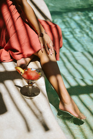 Photoshoot by photographer of woman swimming in pool with cocktail at Viceroy Riviera Maya