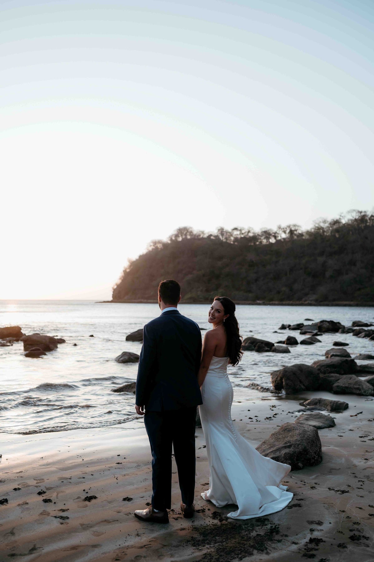 Photograph of a bride and groom on the beach, captured by a DreamArt photographer