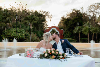 Photograph of bride and groom kissing at their wedding, captured by a DreamArt Photographer 