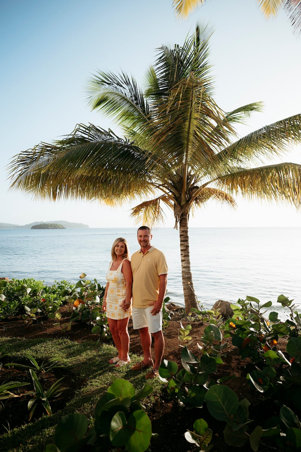 Photograph of a couple holding hands walking outside Secrets St. Lucia luxury hotel