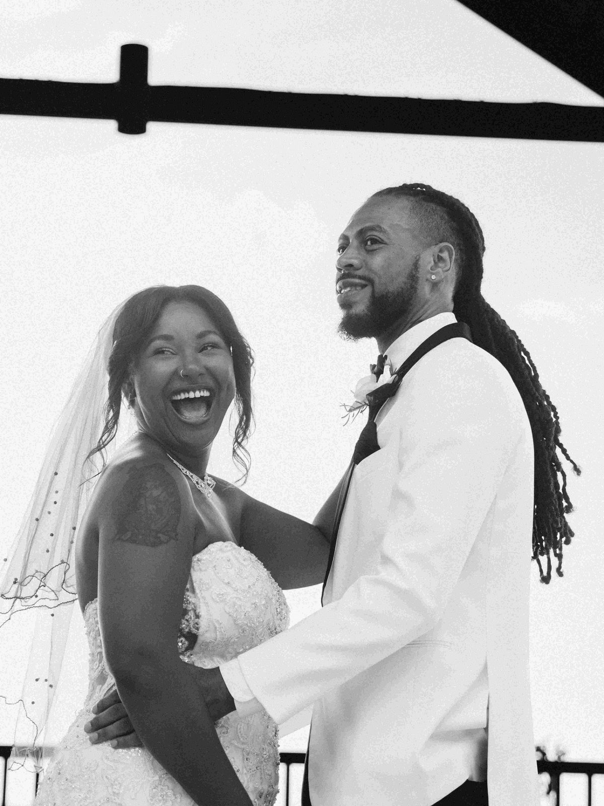 Black and white photograph of a bride and groom at the altar, captured by a DreamArt photographer
