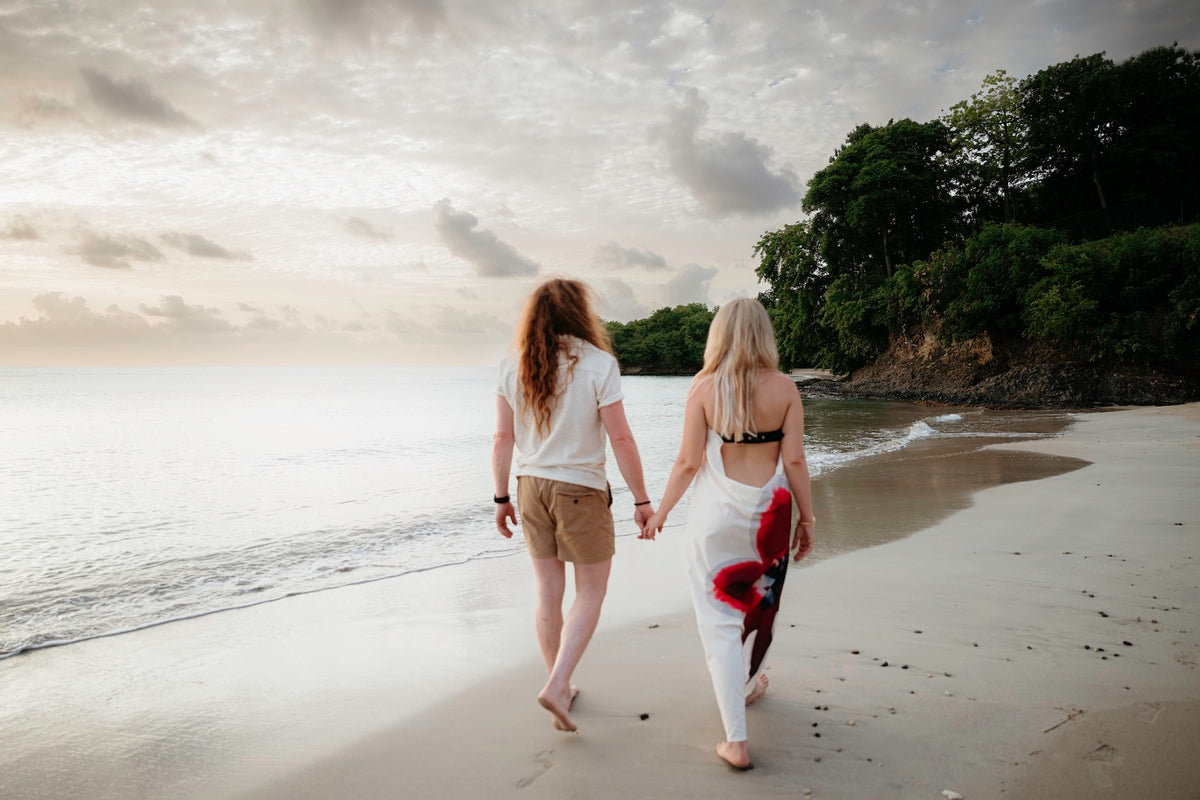 Photograph of a couple wandering along a beach in St. Lucia, holding hands