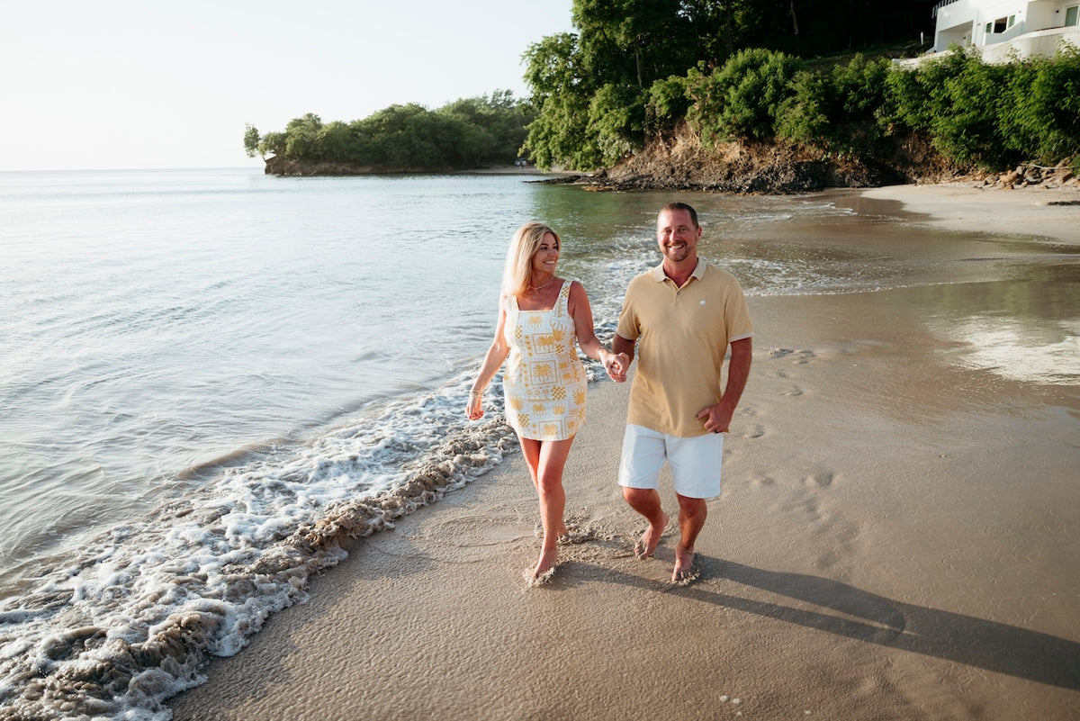 Photograph of a couple walking in the water at the beach in St. Lucia