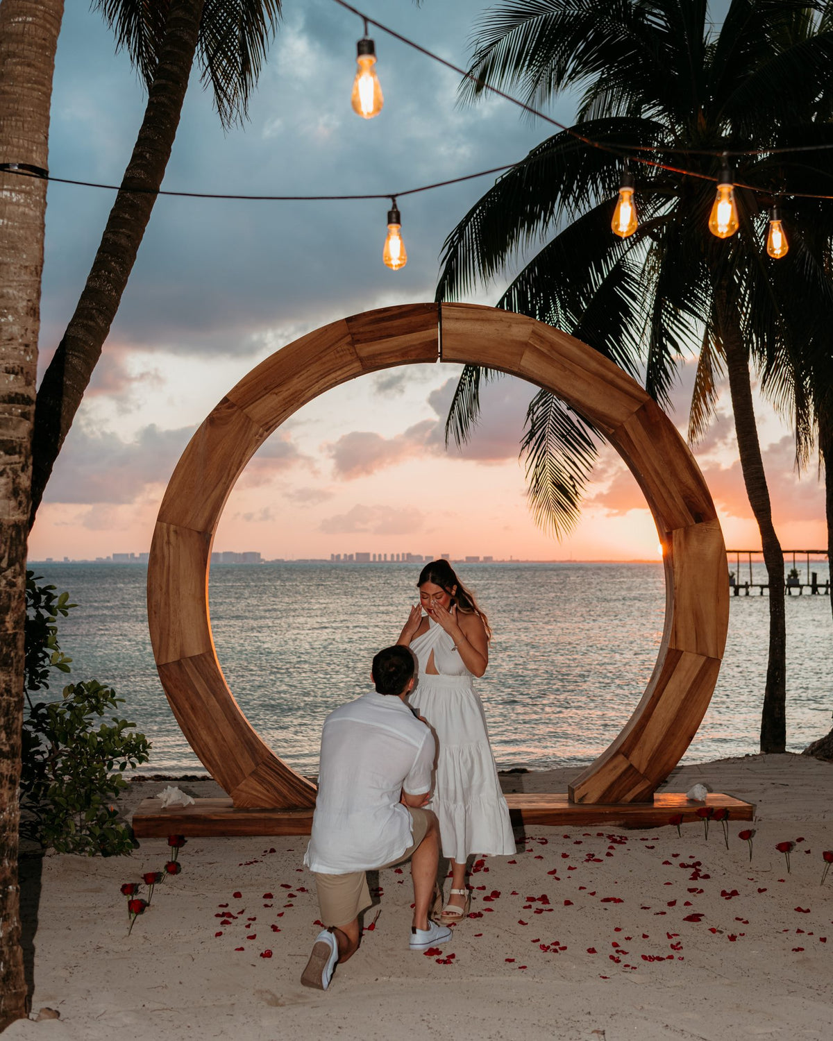 A couple getting engaged on the beach at sunset, captured by a DreamArt Photography Almare Isla Mujeres Photographer