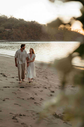 Photograph of a couple walking on the beach holding hands, captured by a DreamArt photographer 