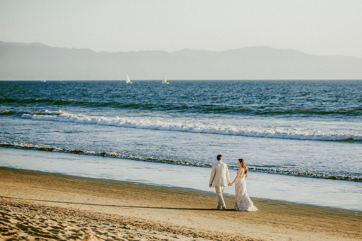 couple walking on the beach of vallarta