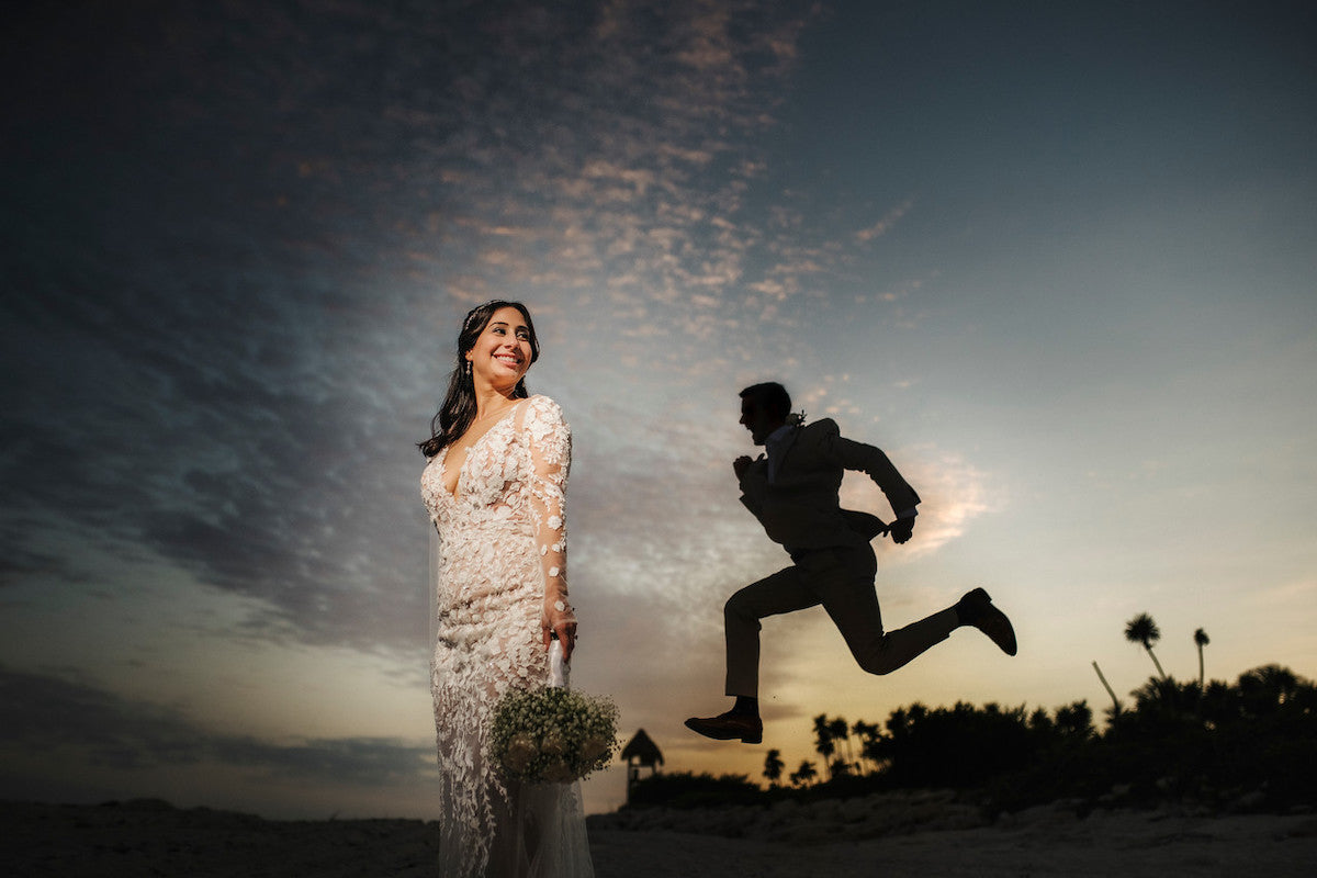Portrait of couple with the groom jumping