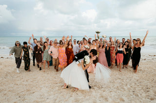 family together at the beach cheering wedding couple 