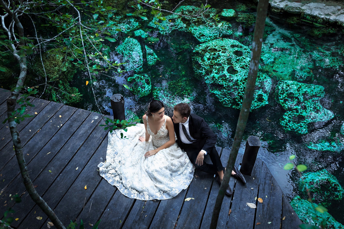 couple with wedding suits near the cenote