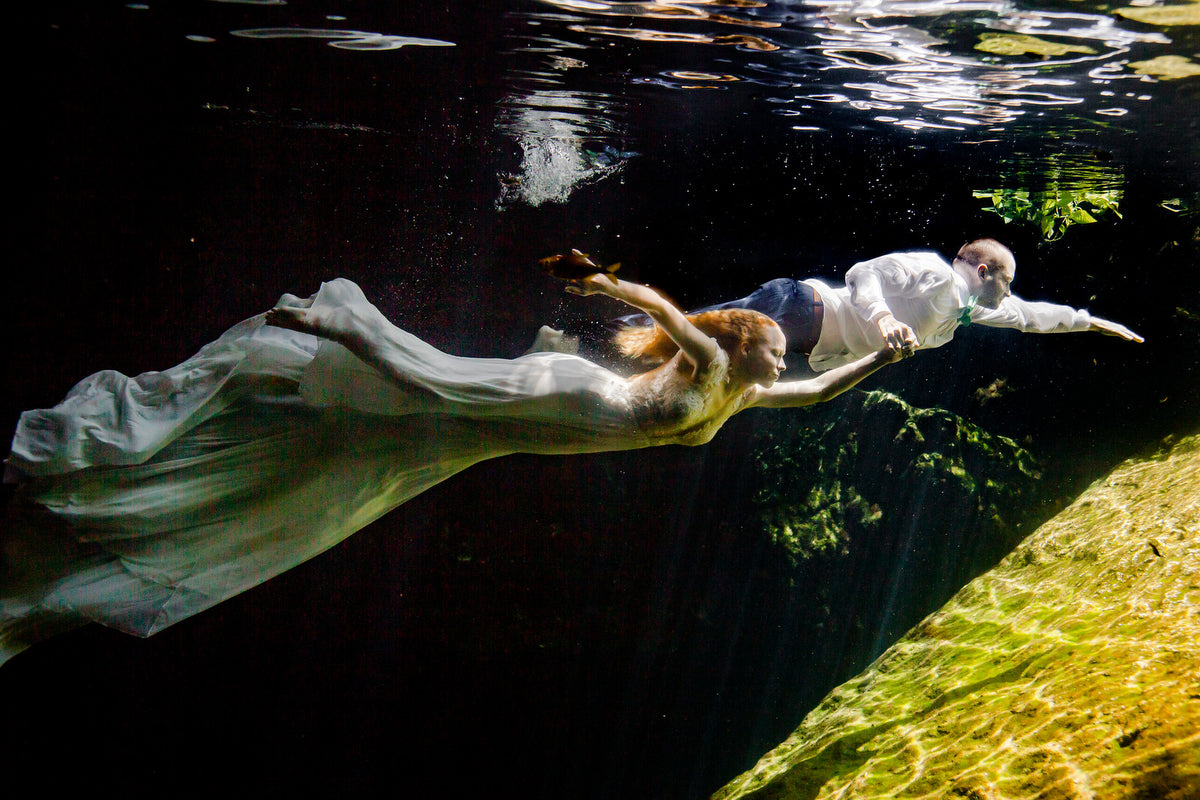 couple during underwater trash the dress