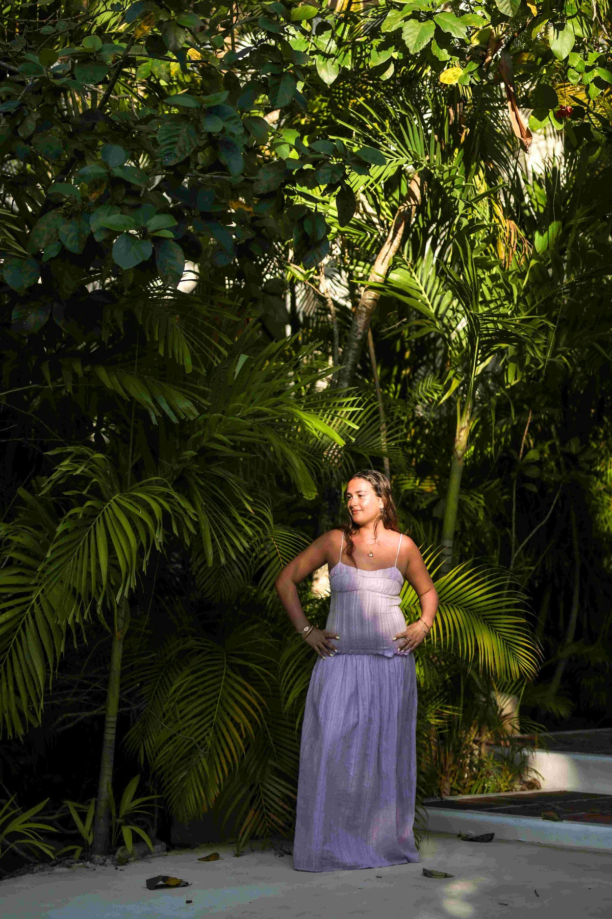 Photograph of a girl posing by the lush greenery at Hotel Esencia
