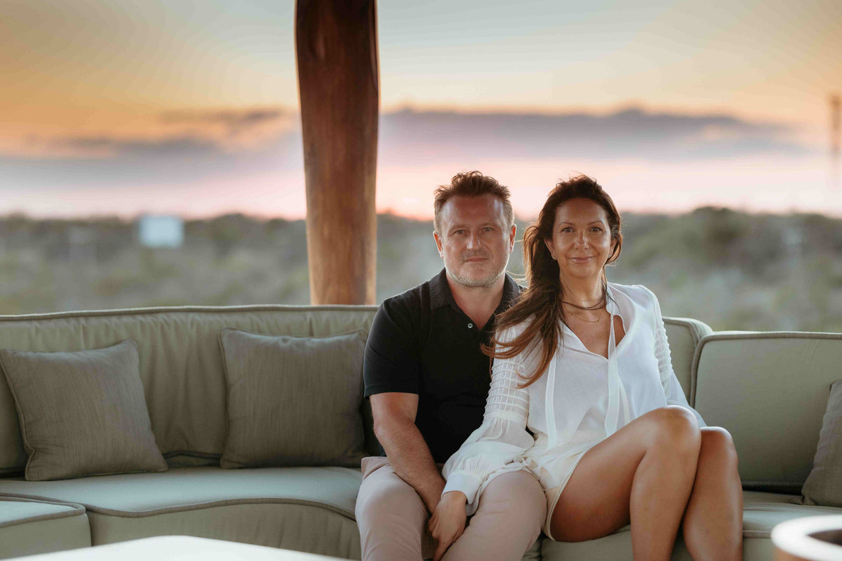 Photograph of husband and wife posing in a lounge area at Hotel Esencia