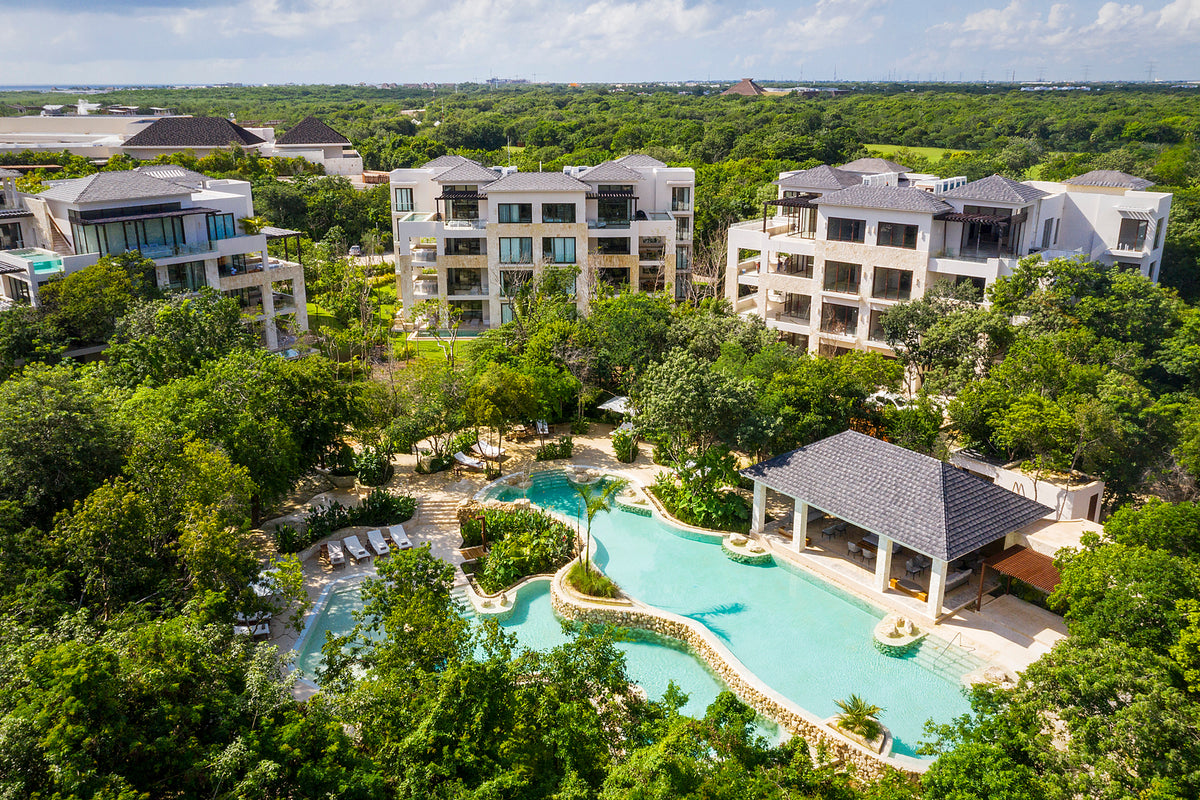 Drone view of the residences and lagoon-style pool surrounded by jungle at Fairmont Mayakoba