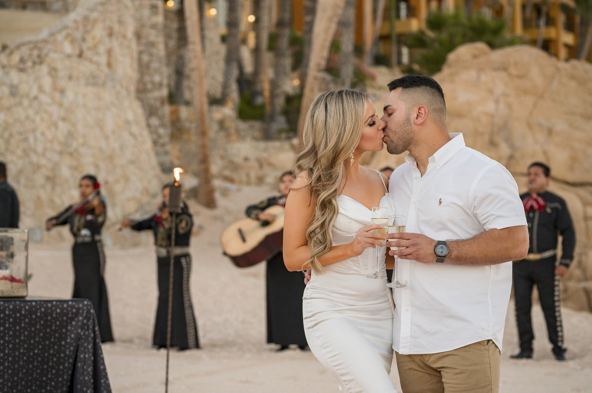Jessica and Alex kiss with the mariachi group in the background