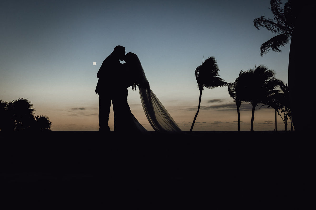 Backlight photo of a newlyweds at Grand Velas Riviera Maya with the moon in the background