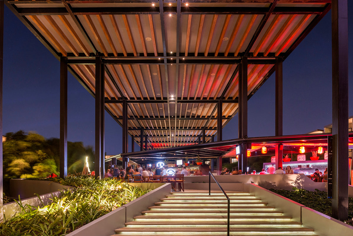 Night hotel photography of an illuminated pergola restaurant terrace and lit staircase at Hyatt