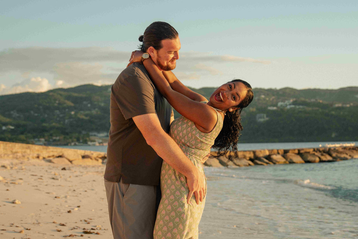 Photograph of a couple embracing on a Jamaican beach