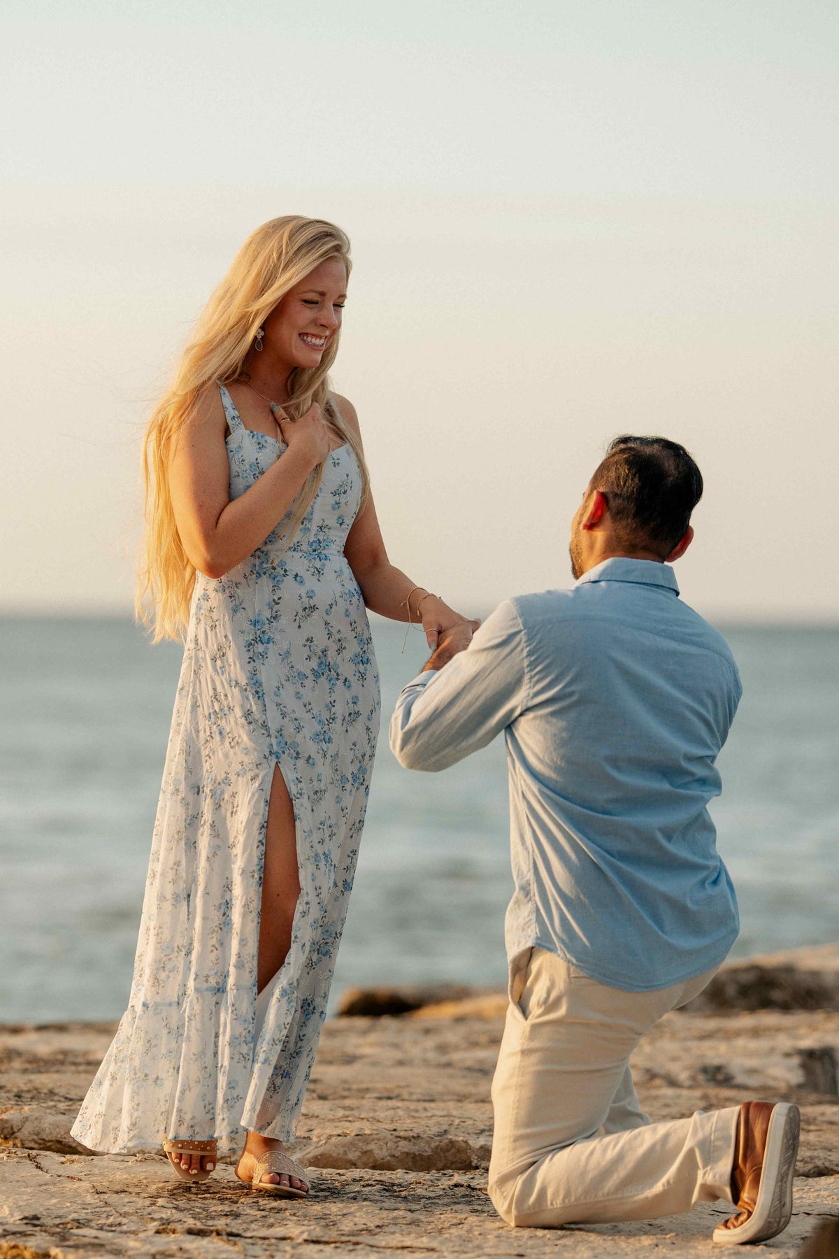 Photograph of man proposing to his partner on a Jamaican beach