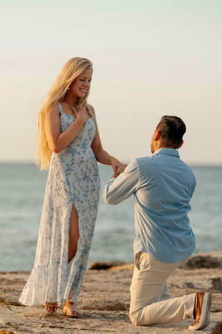 Photograph of man proposing to his partner on a Jamaican beach 
