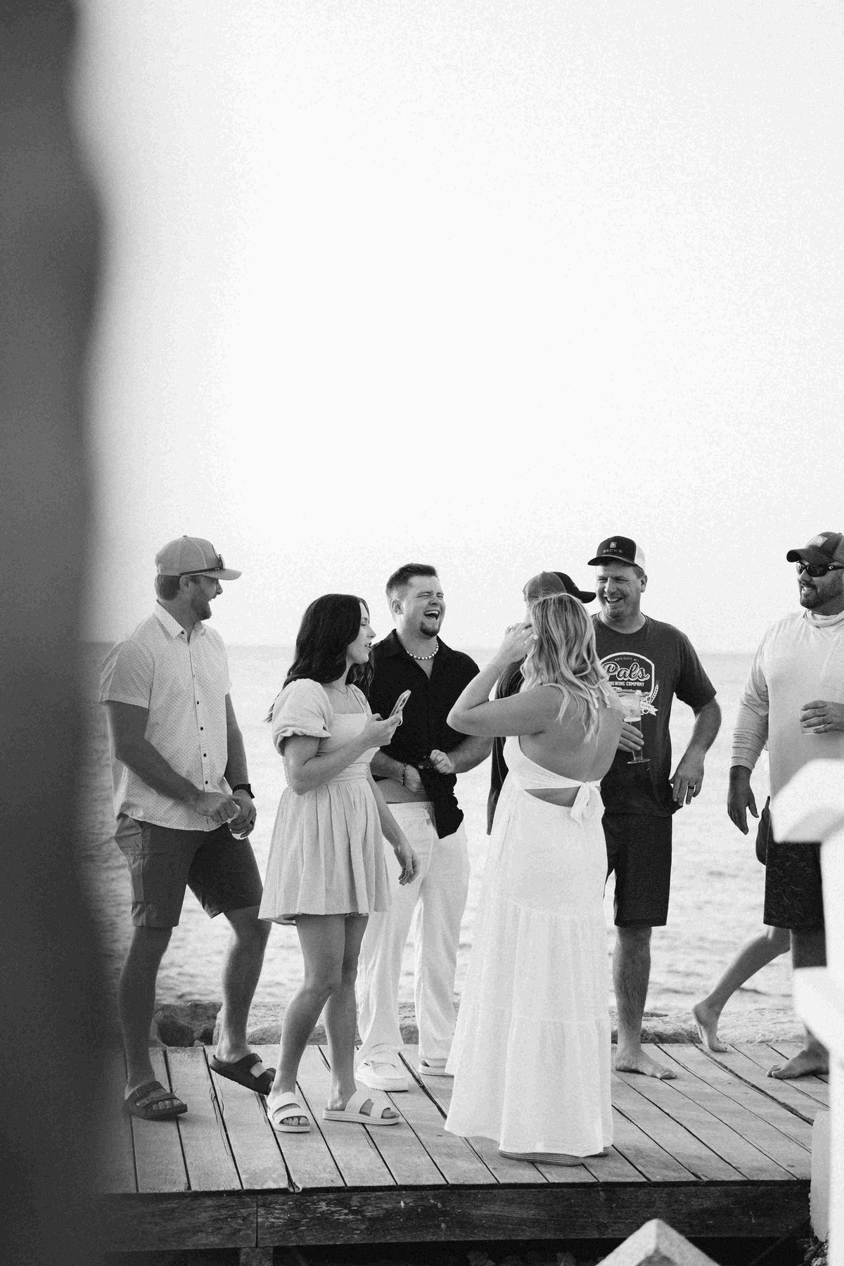 Photograph of bride surrounded by friends and family