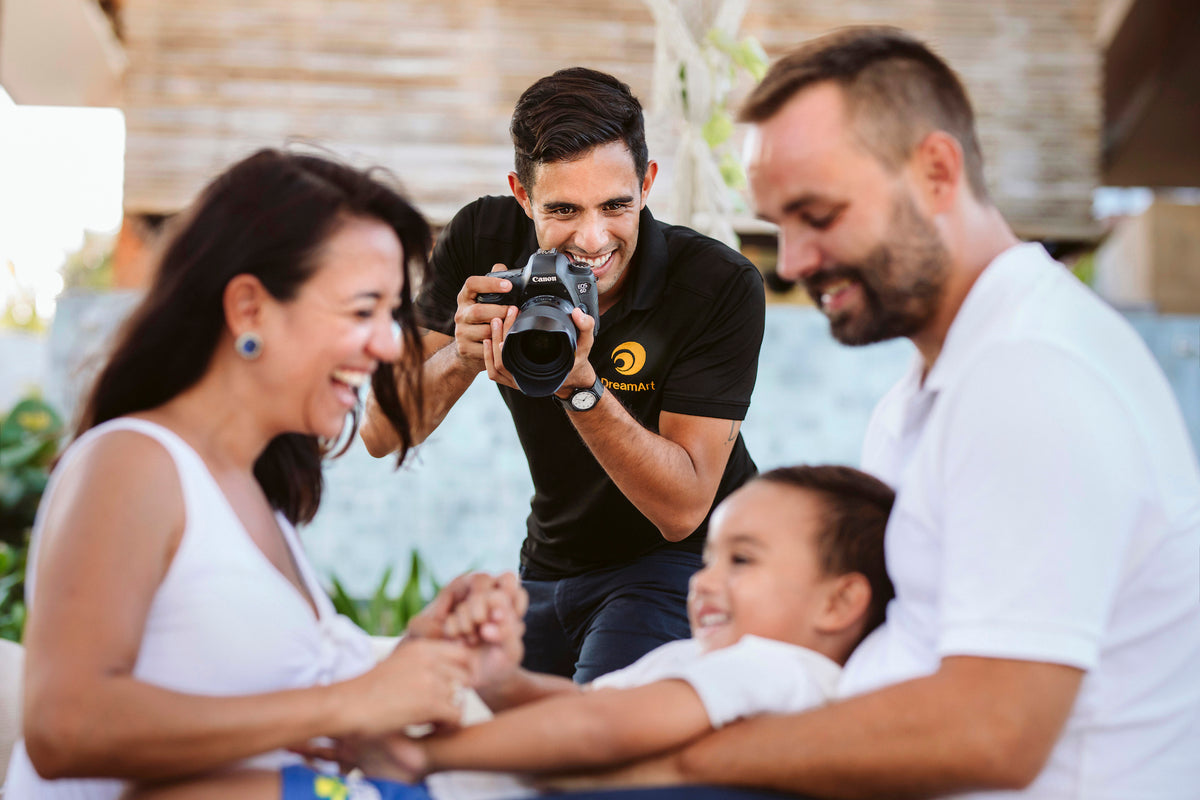 DreamArt photographer captures a laughing mom, dad and young son during a vacation photoshoot