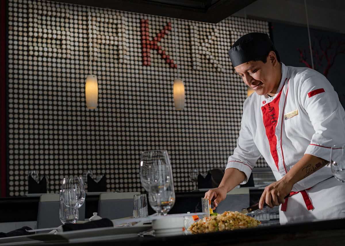 Teppanyaki chef cooking fried rice at the grill in a hotel restaurant at Marquis Los Cabos