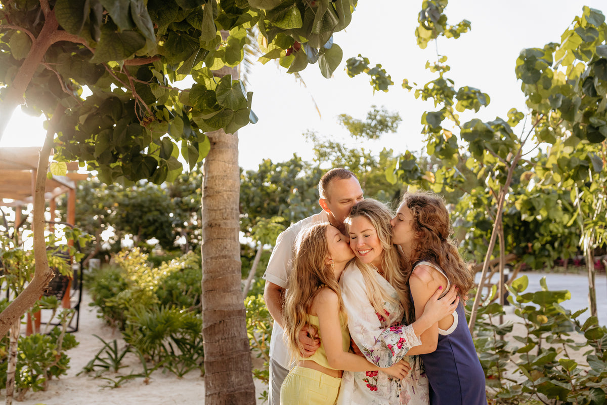 Family hugging during their SLS Playa Mujeres photoshoot