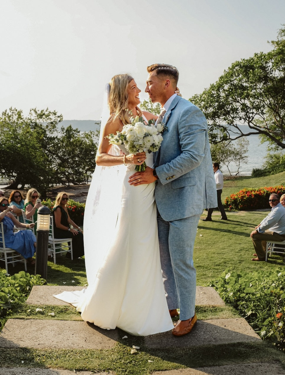 Bride and groom kiss after their garden ceremony overlooking the ocean at Secrets Papagayo Costa Rica