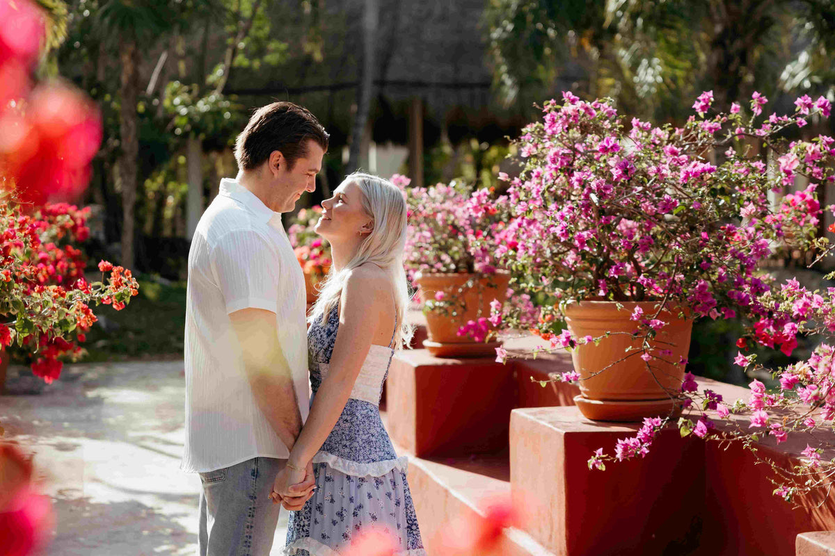 Image of couple embracing in a hotel garden, posing for a DreamArt photographer, used for blog about Summer Trends 2025