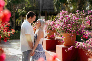 Image of couple embracing in a hotel garden, posing for a DreamArt photographer, used for blog about Summer Trends 2025  