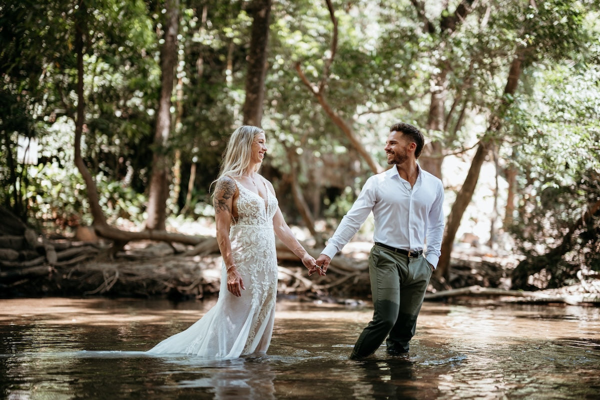 Photograph of a couple walking in water, taken by a DreamArt Photography photographer