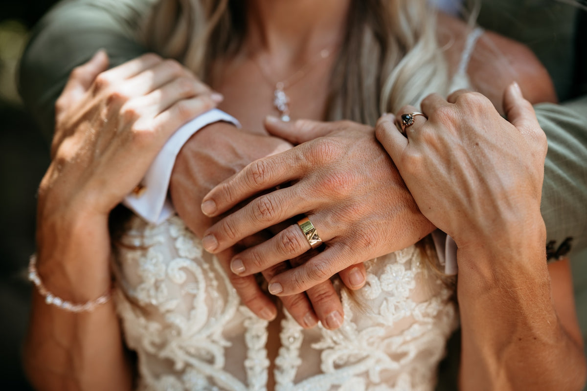 Photograph of the hands of a bride and groom, taken by a DreamArt Photography photographer