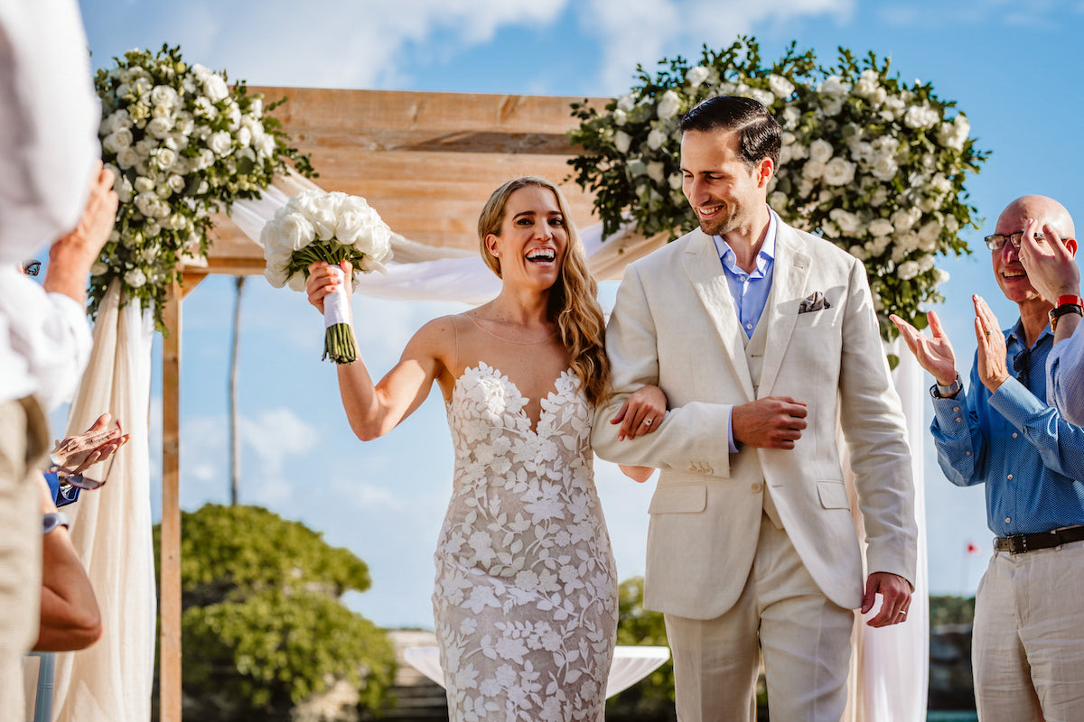 Bride and groom walking down the aisle after saying I do