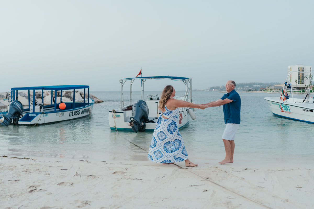 Lifestlye photoshoot with photographer in front of the ocean with boats at Breathless Montego Bay spa & resort in Jamaica