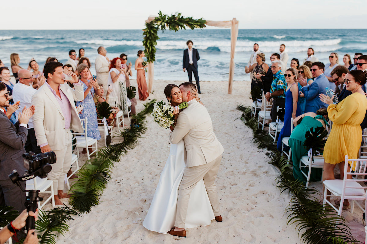 bride and groom embracing down the aisle