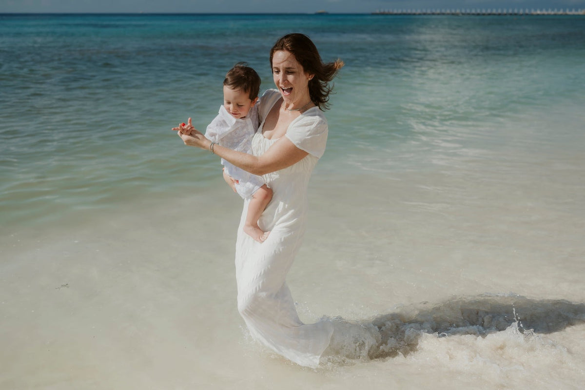 family in ocean during lifestyle photoshoot with photographer at mahekal beach resort